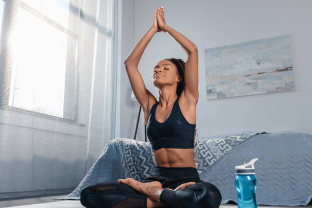 istock woman practicing yoga in padmasana pose 870599688