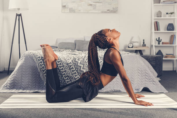 istock woman practicing yoga in cobra pose 870599722