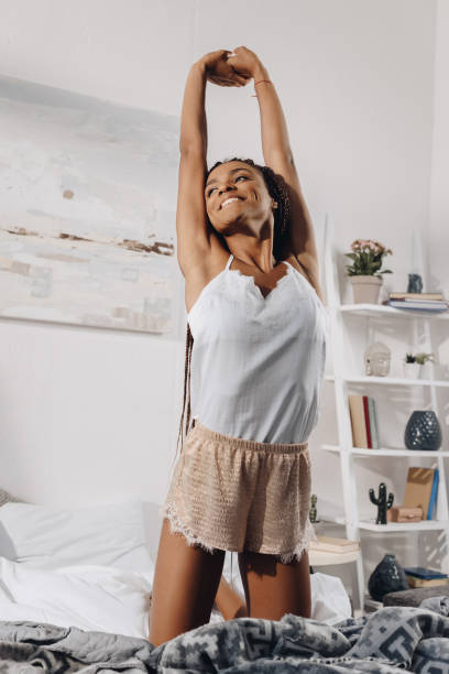 istock woman stretching in bed 870602310