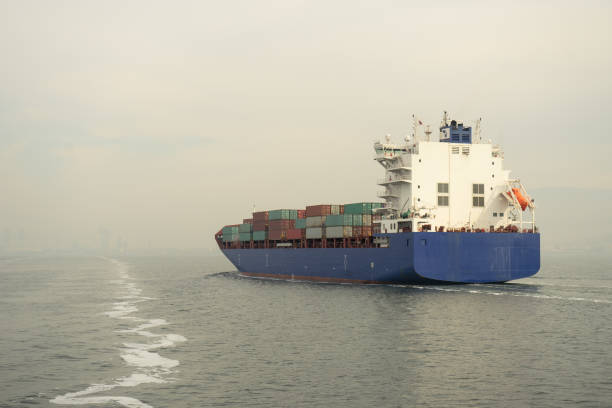 istock Blue container ship cruising at sea. 870602366