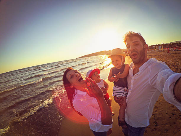 istock Family taking selfie on the beach 870605186