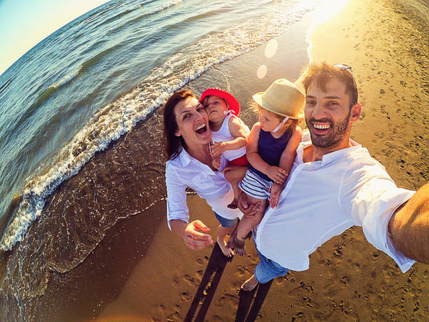 istock Family taking selfie on the beach 870606316