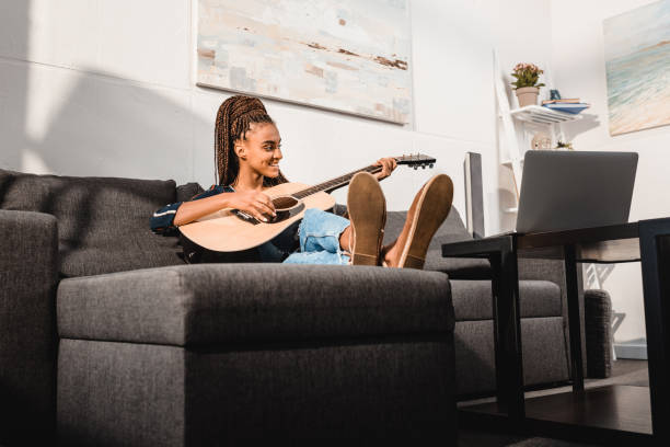 istock woman playing guitar 870609500