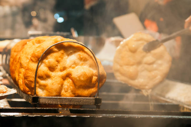 Frying Hungarian traditional Langos food at fair