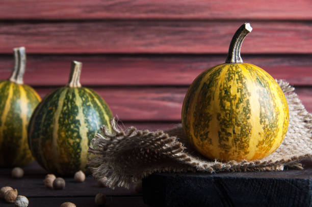 istock Pumpkins on wooden background 870618864
