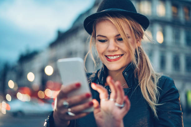 istock Cheerful girl texting in the evening 870622108