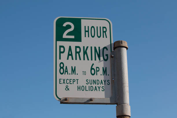 Street sign announcing two hour restricted parking.