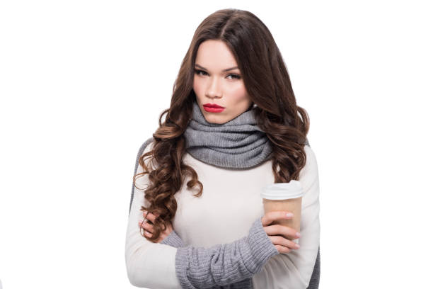 young attractive woman in scarf and arm warmers holding a paper cup, isolated on white