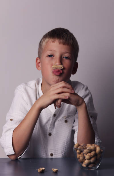 istock Child eating peanuts. Food allergy concept 870637534