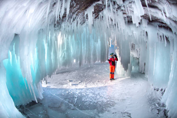 istock Man between the ice rocks on Lake Baikal on a clear day 870640524