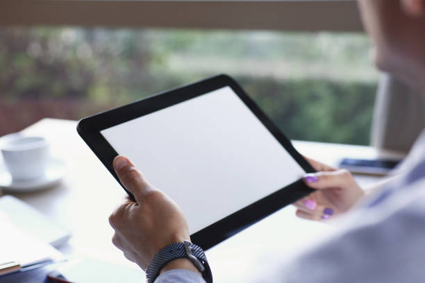 istock Businessman holding tablet in hand in cafe 870640670