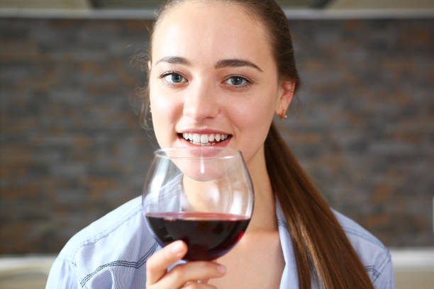 istock Young beautiful attractive girl drinks wine 870640958