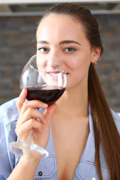 istock Young beautiful attractive girl drinks wine 870640960