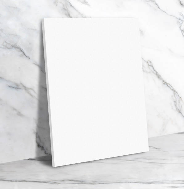 istock Blank white poster canvas in white glossy marble floor leaning at wall,Mock up template for display or montage of design or text,Business presentation 870641518