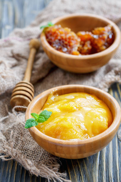 istock Flower honey in bowls and honey dipper. 870685088