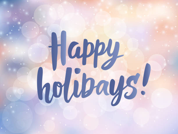 istock Happy holidays text. Hand drawn greetings quote. Blurred lights background with falling snow and bokeh effect. 870687836
