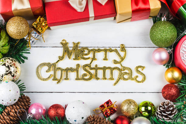 istock Christmas background with decorations and gift boxes on wooden board 870694306