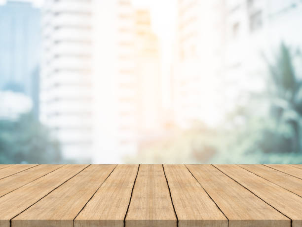 istock Empty wood table top on blurred background at office building,copyspace for montage your products 870694502