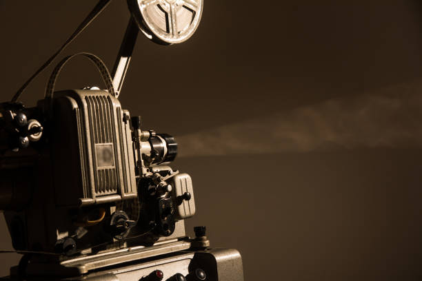 istock Old cinema projector on a dark background 870694504
