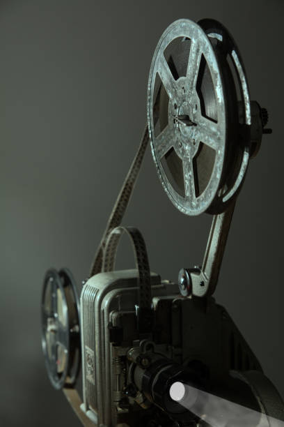 istock Old cinema projector on a dark background 870694530