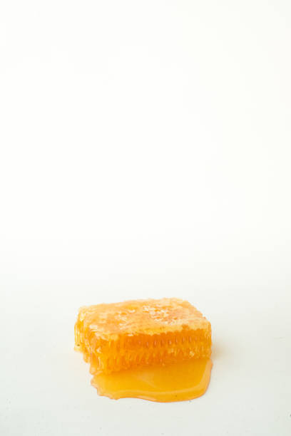 istock Studio image of honeycomb in spilled honey 870701082