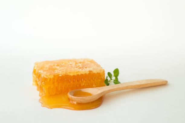 istock Studio image of honeycomb and wooden spoon 870701092