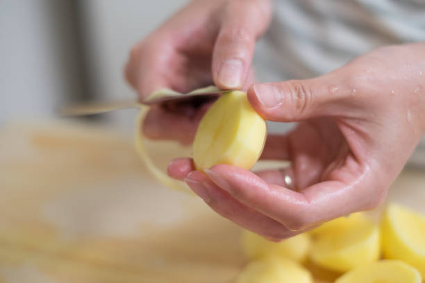 istock housewife peeling potato 870711642
