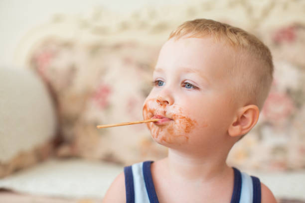 istock Dirty-faced Boy with Ice-Cream Stick in His Mouth 870711992