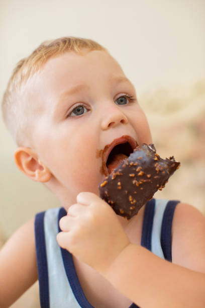 istock Little Dirty-faced Boy Biting Ice-Cream 870712134