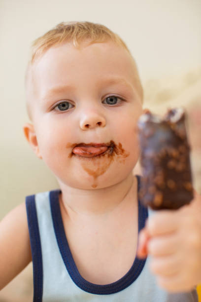 istock Little Dirty-faced Boy Eating Ice-Cream 870712148