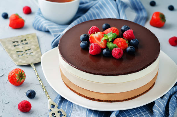 istock Triple chocolate mousse cake decorated with fresh berries 870715176