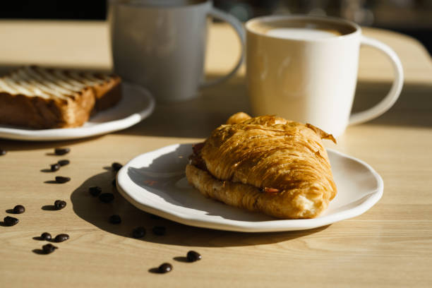 istock Continental breakfast with coffee and croissant 870715798