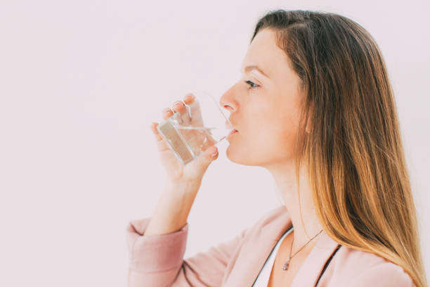 istock Confident young businesswoman drinking water 870718758