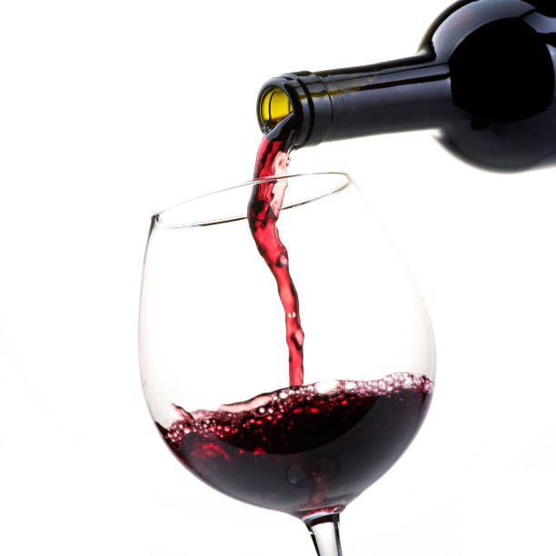 istock Pouring red wine into a wineglass 870726078