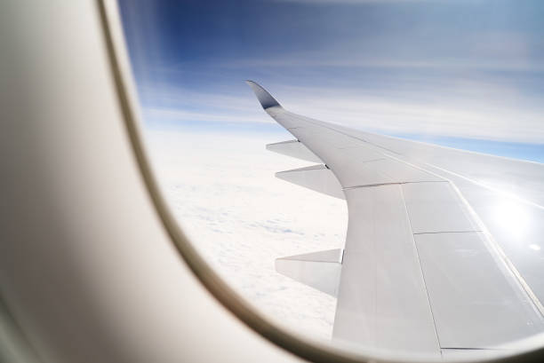 istock Clouds and sky as seen through window of an aircraft 870732896