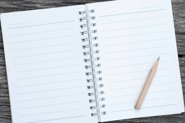 istock Open blank notebook and pencil on wood background. 870738736
