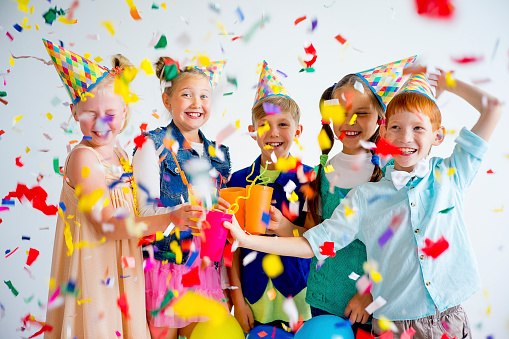 Group of teens on a birthday party with clowns