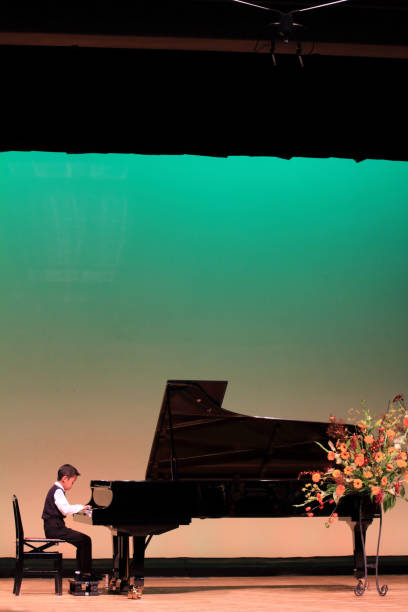 istock Japanese boy playing piano on stage (second grade at elementary school) 870744738