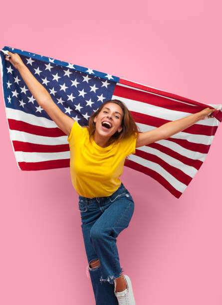 istock Cheerful woman with flag on pink 870744952