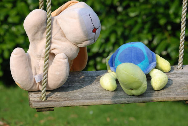 Eco-friendly cute handmade toy on grass at sunny summer day
