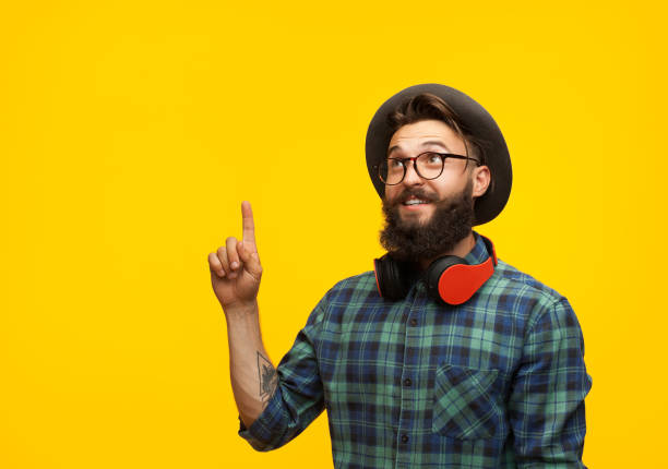 istock Young man pointing up on orange 870766008