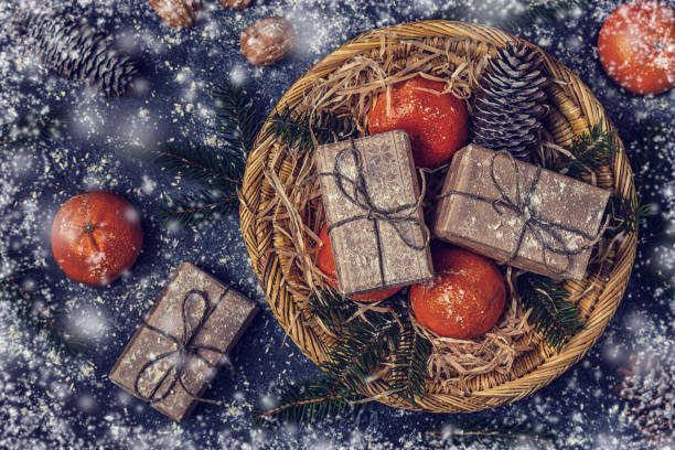 istock Christmas composition with tangerines, gift boxes, cones on dark  background. 870770350