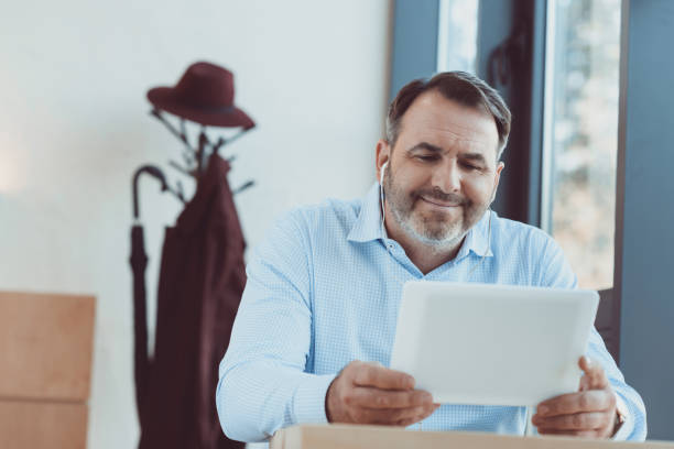 istock man watching movie with tablet 870774554