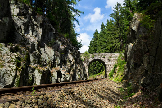 Romantic stone bridge over railway in beautiful forest near Nejdek, Ore Mountains, Czech republic