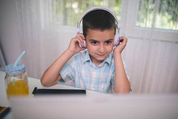 istock Back to School. Little boy using his laptop 870777970