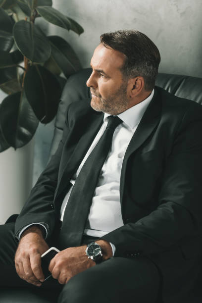 istock businessman sitting on couch 870781528