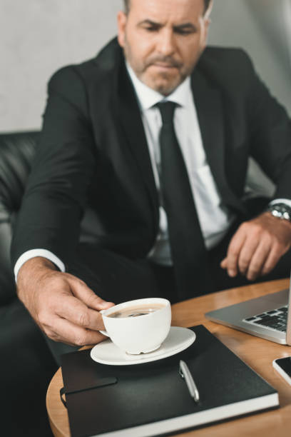 istock businessman with cup of coffee 870781912