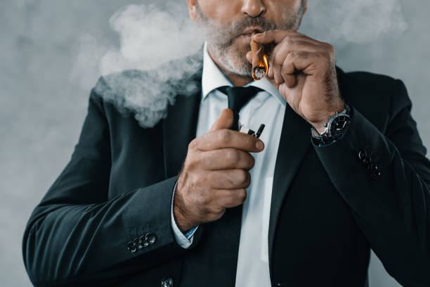 istock businessman in suit smoking cigar 870782014