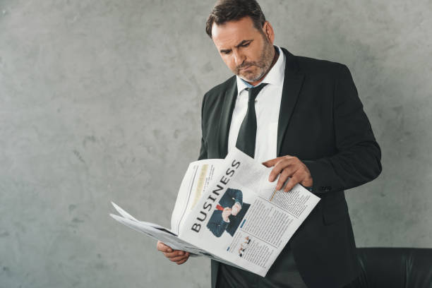 istock businessman reading newspaper 870784434