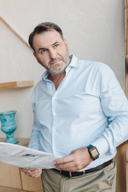 istock mature businessman with newspaper 870784816